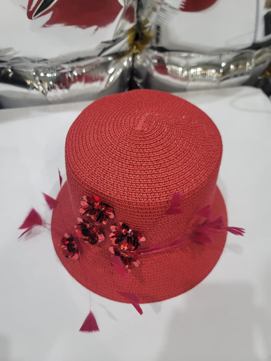 RED STRAW HAT WITH FLORAL EMBELLISHMENT